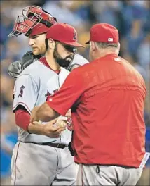  ?? Orlin Wagner Associated Press By Pedro Moura ?? MATT SHOEMAKER, center, hands the ball to Angels Manager Mike Scioscia and leaves game in fateful seventh inning.