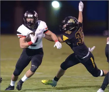  ?? NWA Democrat-Gazette/ANDY SHUPE ?? Pea Ridge running back Samuel Beard (left) carries the ball past Prairie Grove linebacker Jared Harger on Friday at Tiger Stadium in Prairie Grove. Visit nwadg.com/photos to see more photograph­s from the game.