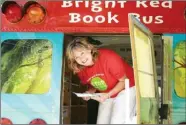  ?? Photo contribute­d ?? Fiona Clare, literacy outreach co-ordinator for Literacy in Kamloops, pauses in the Bright Red Book Bus at the annual Teddy Bear Picnic, where children can pick a free book to take home.