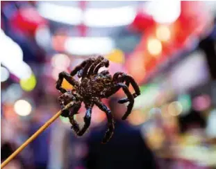  ??  ?? ABOVE: Crispy tarantulas – a gimmick for the tourists, but edible