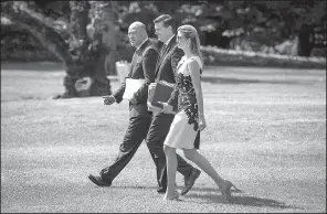  ?? The New York Times/AL DRAGO ?? Gary Cohn (left), President Donald Trump’s chief economic adviser, crosses the White House lawn Wednesday with White House Staff Secretary Rob Porter and Ivanka Trump to accompany Trump on a trip to Springfiel­d, Mo., to push his tax policy. Cohn said...