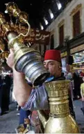  ??  ?? Ishaaq Kremed inspects his ornate brass jug in the covered Hamidiyah market.