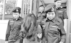  ??  ?? Ling being led away after she was sentenced to death for abetting in the murder of her husband five years ago.