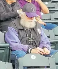  ?? Courtesy of Roger Dudley ?? Rockies’ fan Roger Dudley enjoys his peanuts on opening day 2019 at Coors Field.