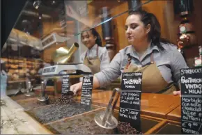  ?? Associated Press photo ?? Employees work at the Starbucks store in Milan, Italy earlier this week.