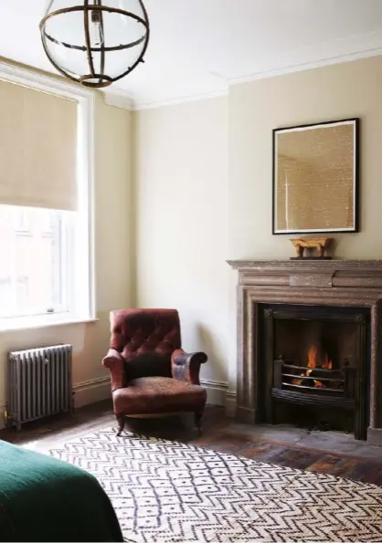  ??  ?? Right The fireplace in the second-floor bedroom is a version of a Lutyens original, made of Derbyshire fossil marble and bought from Castle Howard. A zig-zag, monochrome rug softens the reclaimed narrow boards, used throughout the house. The armchair...