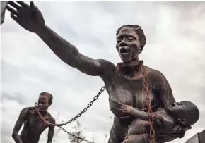  ?? HUMAN PICTURES ?? Ghanaian artist Kwame Akoto Bamfo created a sculpture of chained and kidnapped Africans for the area leading up to the new national lynching memorial.