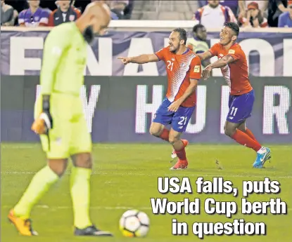  ?? Getty Images ?? TALLY D’OH! U.S. goalkeeper Tim Howard (left) looks away in dejection as Costa Rica’s Marco Urena (center) celebrates his goal with teammate Johan Venegas on Friday in Harrison, N.J.