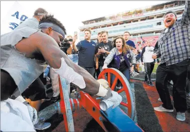  ??  ?? Las Vegas Review-journal file UNR running back James Butler paints the Fremont Cannon blue after the Wolf Pack beat UNLV 45-10 on Thanksgivi­ng weekend in 2016 at Sam Boyd Stadium. The rivalry game drew an announced crowd of just 23,569.