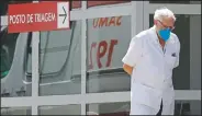  ?? (AP/Eraldo Peres) ?? A doctor gets some fresh air as he takes a walk outside the HRAN Hospital in Brasilia, Brazil.