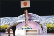  ?? BEHROUZ MEHRI — POOL PHOTO ?? Japan’s Emperor Naruhito, right, and Empress Masako bow in front of the altar for victims of the earthquake and tsunami at the national memorial service in Tokyo on Thursday.