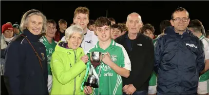  ??  ?? George Slattery receives the Joe Brennan Memorial Cup from Joe’s daughter and son, Ann and Paul, as Marguerite Furlong (Coiste na nOg Chairperso­n) and Alan Aherne (Group Sports Editor, People Newspapers) look on.