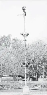  ?? BRIAN CLARK WATERLOO REGION RECORD FILE PHOTO ?? Morris Kesselring on Oct. 26, 1979 replaces a badly faded Canadian flag on the flagpole in Victoria Park lake. The flag drew complaints so Kesselring volunteere­d to untangle the lanyard and replace the flag.