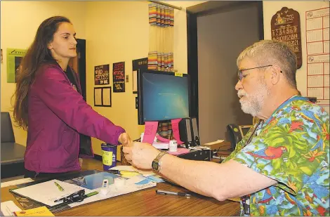  ?? SUBMITTED PHOTOS ?? Faith Chambers, left, a senior at Maurice J. McDonough High School, gets a blister on her hand inspected by school nurse D.W. Stephenson.