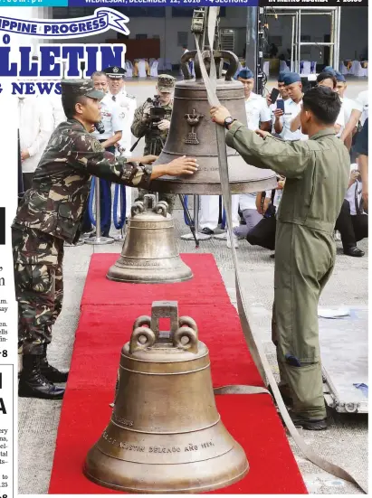  ?? (Czar Dancel) ?? HOME AFTER 117 YEARS – A crane sets the three bells in place for the ceremonial turnover at Villamor Air Base Tuesday. The bells were back in the Philippine­s 117 years after they were taken as spoils of war by American troops.