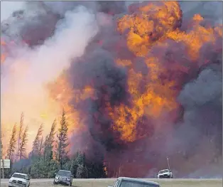  ?? CP PHOTO ?? A giant fireball is visible as a wildfire rips through the forest by Highway 63, 16 kilometres south of Fort Mcmurray, Alta on May 7, 2016.