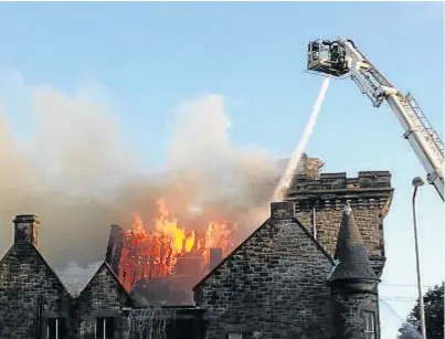  ?? Picture: Andrew Donald. ?? Firefighte­rs used a tall platform to douse the flames from above.