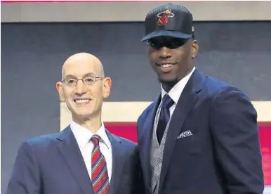  ?? MIKE STOBE/GETTY IMAGES ?? Bam Adebayo poses with NBA commission­er Adam Silver after being drafted 14th overall by the Miami Heat during the first round.