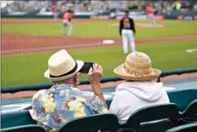  ??  ?? Two older adults watch a Pittsburgh Pirates and the Photo/Gene J. Puskar, File) spring training exhibition baseball game between the Baltimore Orioles on March 22 in Bradenton, Fla. (AP