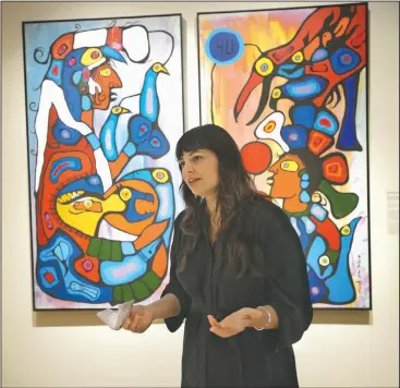  ?? NWA Democrat-Gazette/ANDY SHUPE ?? Independen­t curator Candice Hopkins speaks Thursday about a painting by Norval Morrisseau titled The Story Teller: The Artistand His Grandfathe­r during a tour of a new exhibition of art by Native American artists at Crystal Bridges Museum of American Art in Bentonvill­e. The exhibition, Art for a New Understand­ing: Native Voices, 1950s to Now, opens today and runs through Jan. 7.