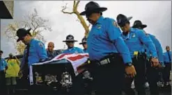  ?? AP ?? Body of cop killed by Hurricane Maria is carried from debris. President Trump says his administra­tion did a great job, despite carnage.