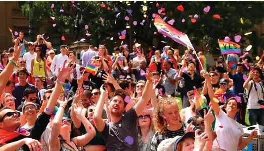  ??  ?? Crowds celebrate in Melbourne as the results of the Australian marriage equality vote are announced. Photo: Scott Barbour/Getty Images