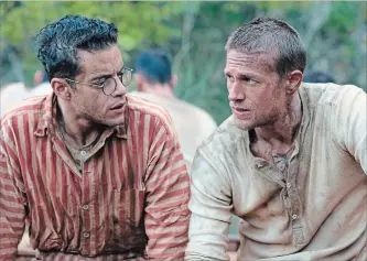  ?? JOSE HARO THE ASSOCIATED PRESS ?? Rami Malek, left, and Charlie Hunnam are pictured in a scene from the remake of "Papillon," which is primarily a buddy picture, but one that depicts lots and lots of human suffering.