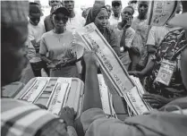  ?? Sunday Alamba/Associated Press ?? Election officials count ballots in front of observers in Yola, Nigeria. Some were casting votes well into the night.