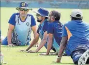  ??  ?? Jharkhand captain M S Dhoni (left) with teammates during a