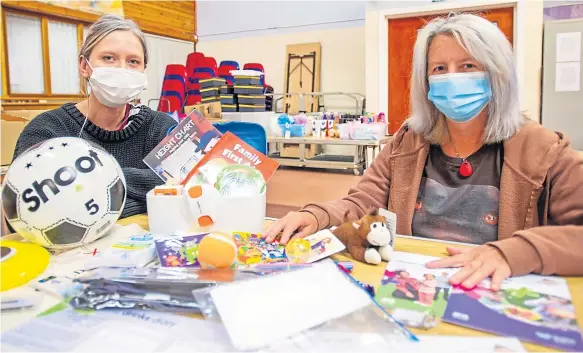  ??  ?? Senior money advice worker Fay Costello, left, and Ginny Lawson with some of the contents of the safety boxes.