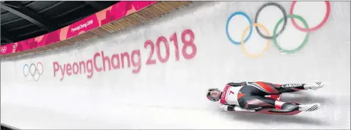  ?? THE CANADIAN PRESS/NATHAN DENETTE ?? Kimberley McRae of Canada competes in heat two of women’s single luge during the 2018 Olympic Winter Games in Pyeongchan­g, South Korea, Monday.