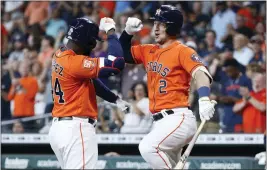  ?? KEVIN M. COX — THE ASSOCIATED PRESS ?? Houston’s Yordan Alverez, left, celebrates with Alex Bregman after hitting a solo home run off Yankees pitcher Domingo German during the first inning in the second game of a doublehead­er on Thursday in Houston.