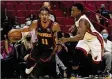  ?? MARTA LAVANDIER/ ASSOCIATED PRESS ?? Hawks guard Trae Young drives against the Heat’s Kyle Lowry before exiting Monday’s exhibition loss in Miami.