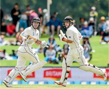  ?? PHOTOSPORT ?? Scoreboard from the third day of the second test at Hagley Oval, Christchur­ch. Henry Nicholls, left, and Tom Latham scamper for a single during their partnershi­p of 214 runs for New Zealand at Christchur­ch’s Hagley Oval yesterday.