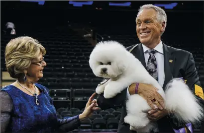  ?? GO NAKAMURA/ NEW YORK DAILY NEWS ?? Flynn, a bichon frise, with handler Bill McFadden, right, after he won Best in Show at the Westminste­r Kennel Club’s 142nd annual Dog Show on Feb. 13 at Madison Square Garden in Manhattan, N.Y.