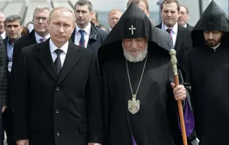  ?? Alexei Nikolsky, RIA-Novosti, Kremlin Pool Photo via The Associated Press ?? Russian President Vladimir Putin, left, and Armenian Apostolic Church leader Catholicos Garegin II walk to attend a memorial service in the Tsitsernak­aberd Genocide memorial complex in Yerevan, Armenia, on Friday.