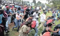  ??  ?? BACKING OFF: Students flee during clashes with police.