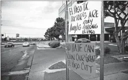  ?? LOLA GOMEZ/AUSTIN AMERICAN-STATESMAN ?? Signs outside an El Paso hospital sum up the feelings of residents after the rampage.