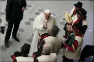  ?? ?? Pope Francis speaks to bagpipe players at the end of his weekly general audience in the Paul VI Hall, at the Vatican, Wednesday.