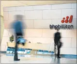  ?? Picture: BLOOMBERG, IAN WALDIE ?? FORCE: People walk through the foyer of the BHP Billiton Ltd. headquarte­rs in Melbourne, Australia, in this file picture taken last year.