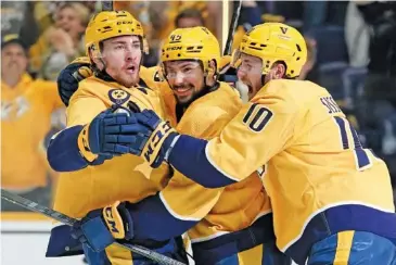  ?? AP PHOTO/MARK HUMPHREY ?? From left, the Nashville Predators’ Yakov Trenin celebrates with teammates Alexandre Carrier and Colton Sissons after Trenin scored his second goal of a playoff game against the Colorado Avalanche on May 9 in Nashville.