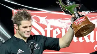  ?? MARK TAYLOR/FAIRFAX NZ ?? Richie McCaw holds up the Steinlager Trophy after a win against Wales in 2010. Alcohol sponsorshi­p of rugby has fallen since its heyday in the 1980s and 1990s.