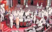  ?? PTI ?? Opposition members create a ruckus in the Rajya Sabha on Monday over former BJP MP Tarun Vijay’s remarks.