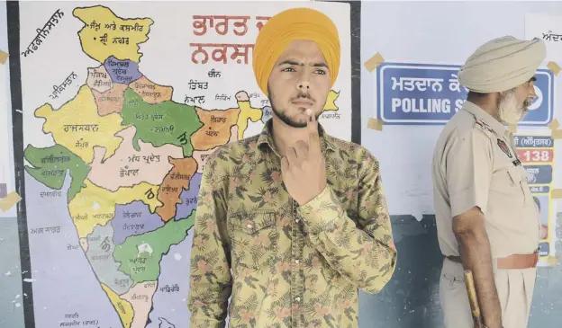  ?? PICTURE; AFP ?? 0 A first time voter shows his ink-marked finger after casting his vote near the India Pakistan Wagah border post yesterday