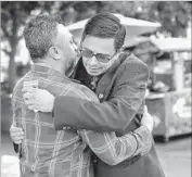  ??  ?? MIGUEL LUNA, left, hugs Adan Ortego, a Fullerton resident who runs a government affairs firm, who agreed to be part of Luna’s “Power of U” project.