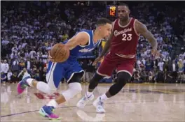  ?? KYLE TERADA, USA TODAY SPORTS ?? Golden State Warriors’ guard Stephen Curry, left, dribbles past Cleveland Cavaliers’ forward LeBron James in the fourth quarter at Oracle Arena on Friday.