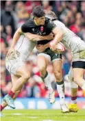  ?? Photo / AP ?? Louis Rees-zammit of Wales attempts to offload in a double tackle by Georgia defenders in Cardiff.