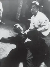  ?? LOS ANGELES TIMES VIA AP FILE PHOTO ?? In this June 5, 1968, file photo, Ambassador Hotel busboy Juan Romero, right, comes to the aid of Sen. Robert F. Kennedy, as he lies on the floor in Los Angeles moments after he was shot.