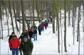  ?? COURTESY OF LAKE METROPARKS ?? Dan Burnett, in foreground, leads hikers during a previous winter hike at Penitentia­ry Glen Reservatio­n in Kirtland.