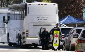  ?? Associated Press ?? Police investigat­ors work around a bus which is believed to be the site of an overnight shooting on the grounds of the University of Virginia on Monday in Charlottes­ville, Va.